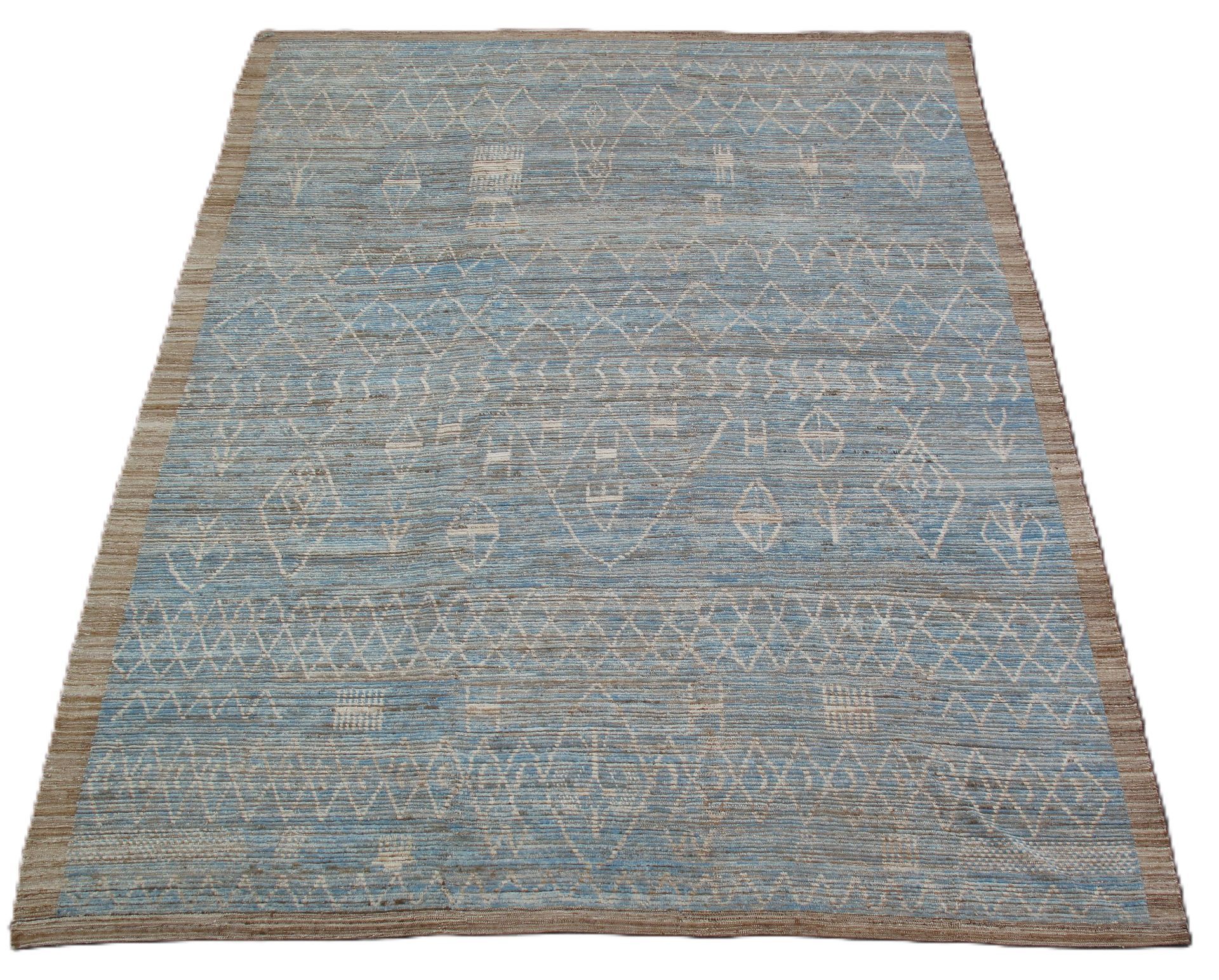 Blue-gray textured area rug with tan edges on a white background