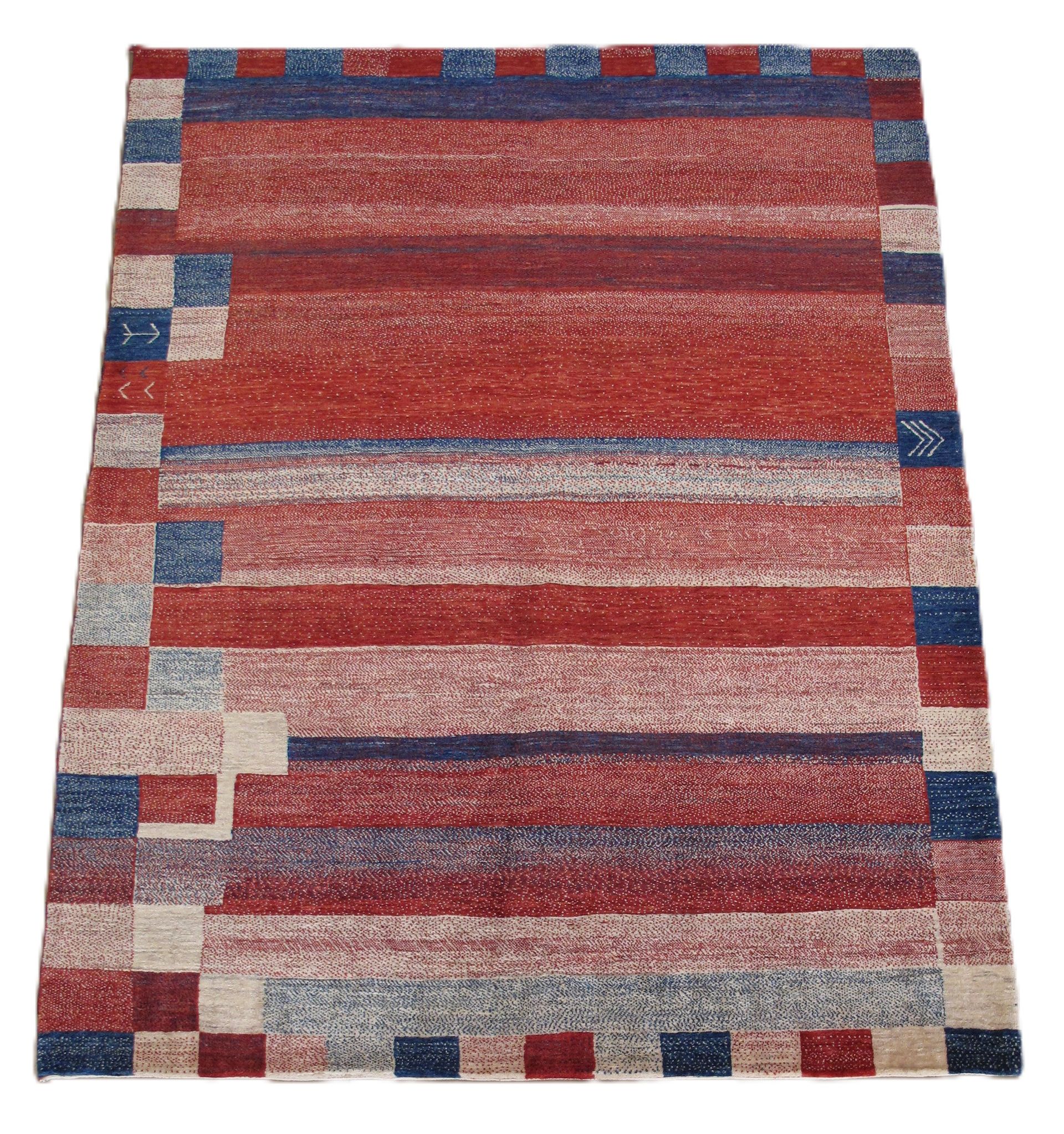 Red and blue geometric rug with a striped pattern and a framed border.