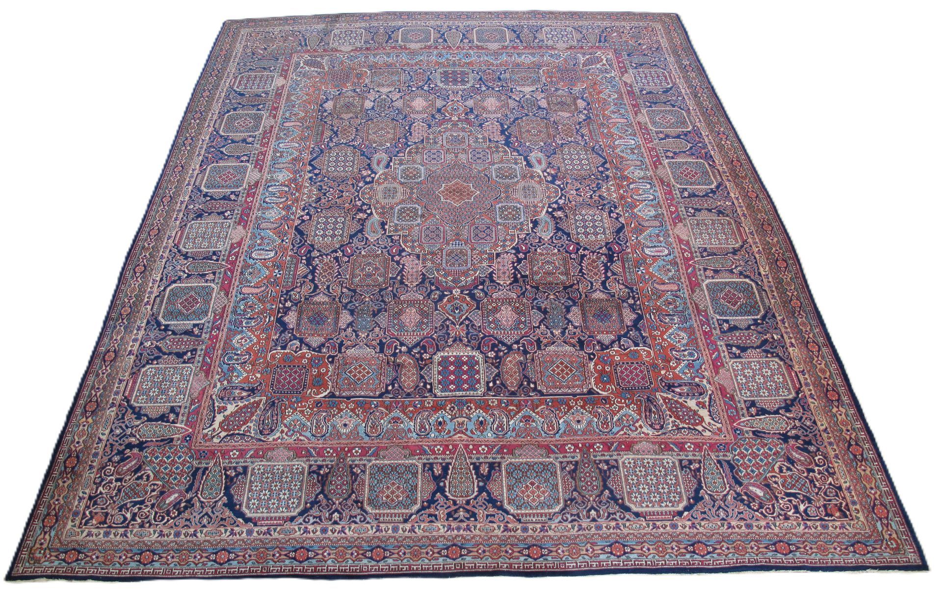 Large antique Persian rug with intricate floral and geometric patterns, blue and red hues.