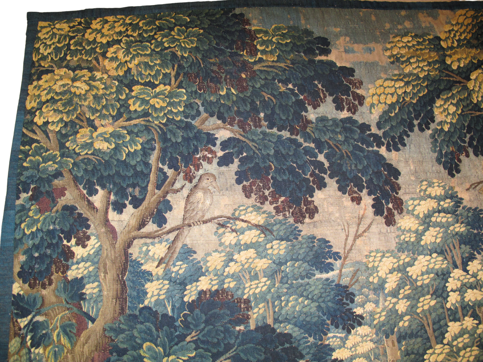 A painting of a landscape with trees and a river