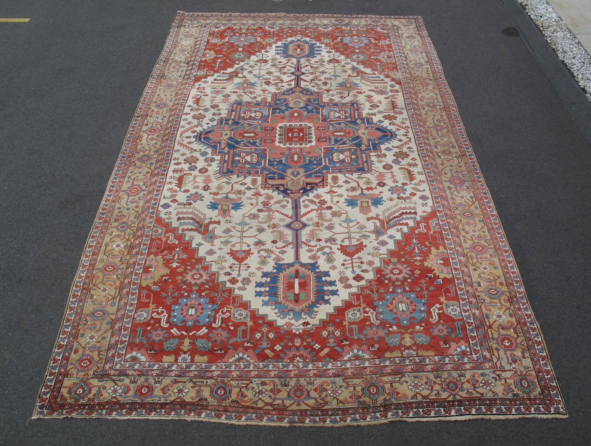 antique Persian Serapi rug with central medallion in a red and ivory palette, 12' x 20'9