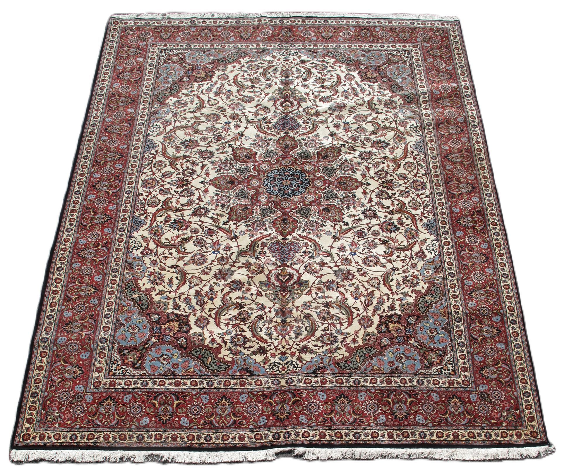 Ornate beige and red patterned area rug with a floral center and border