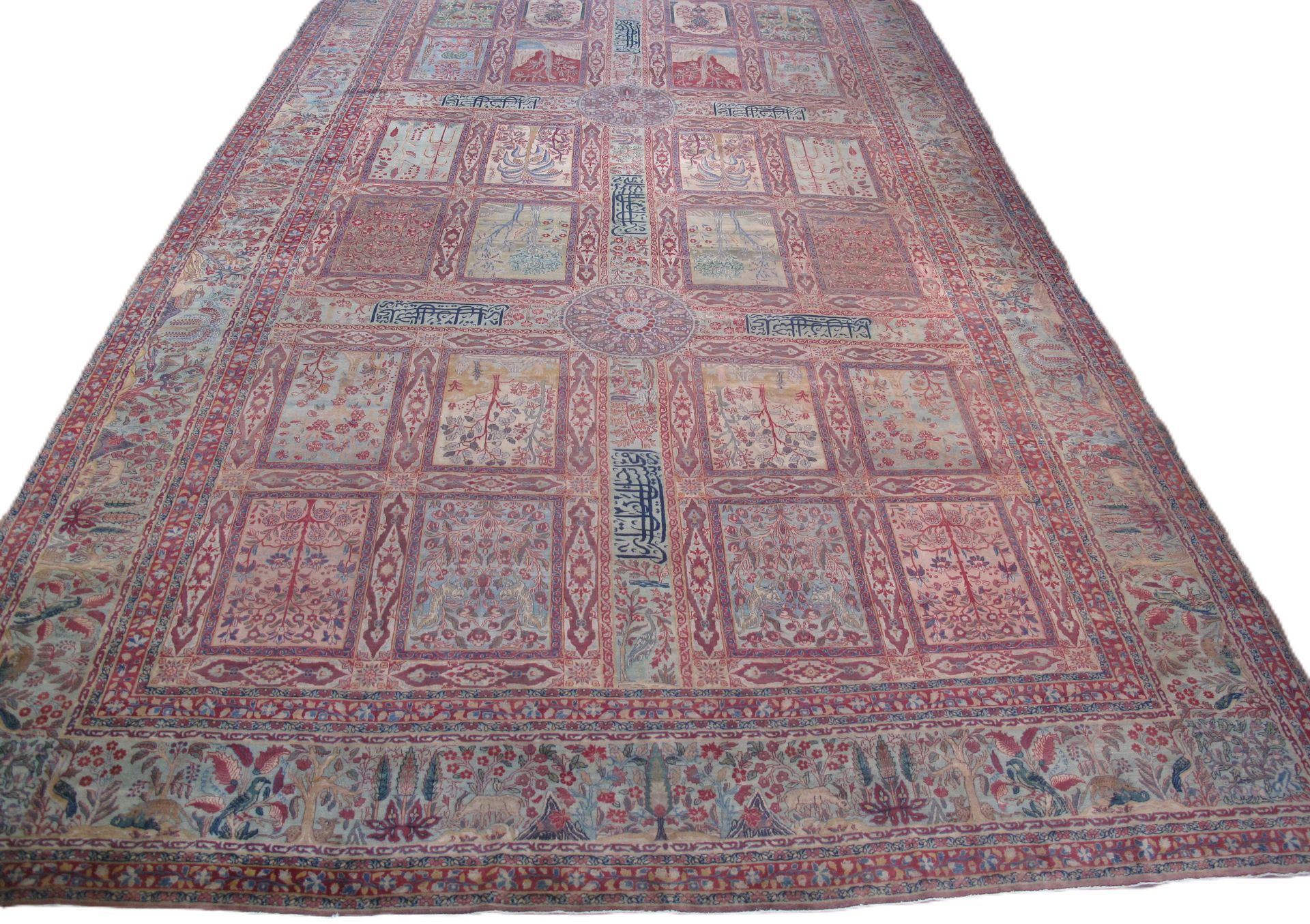 A large, rectangular rug featuring a grid of ornate, pale floral panels set against a pink-toned, patterned field.