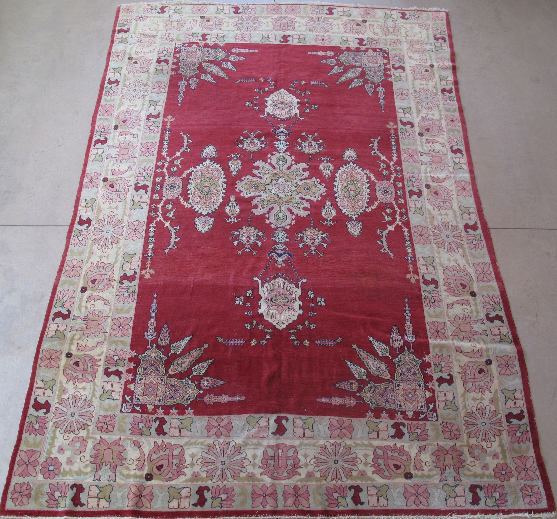Red and beige patterned area rug with an ornate central medallion design