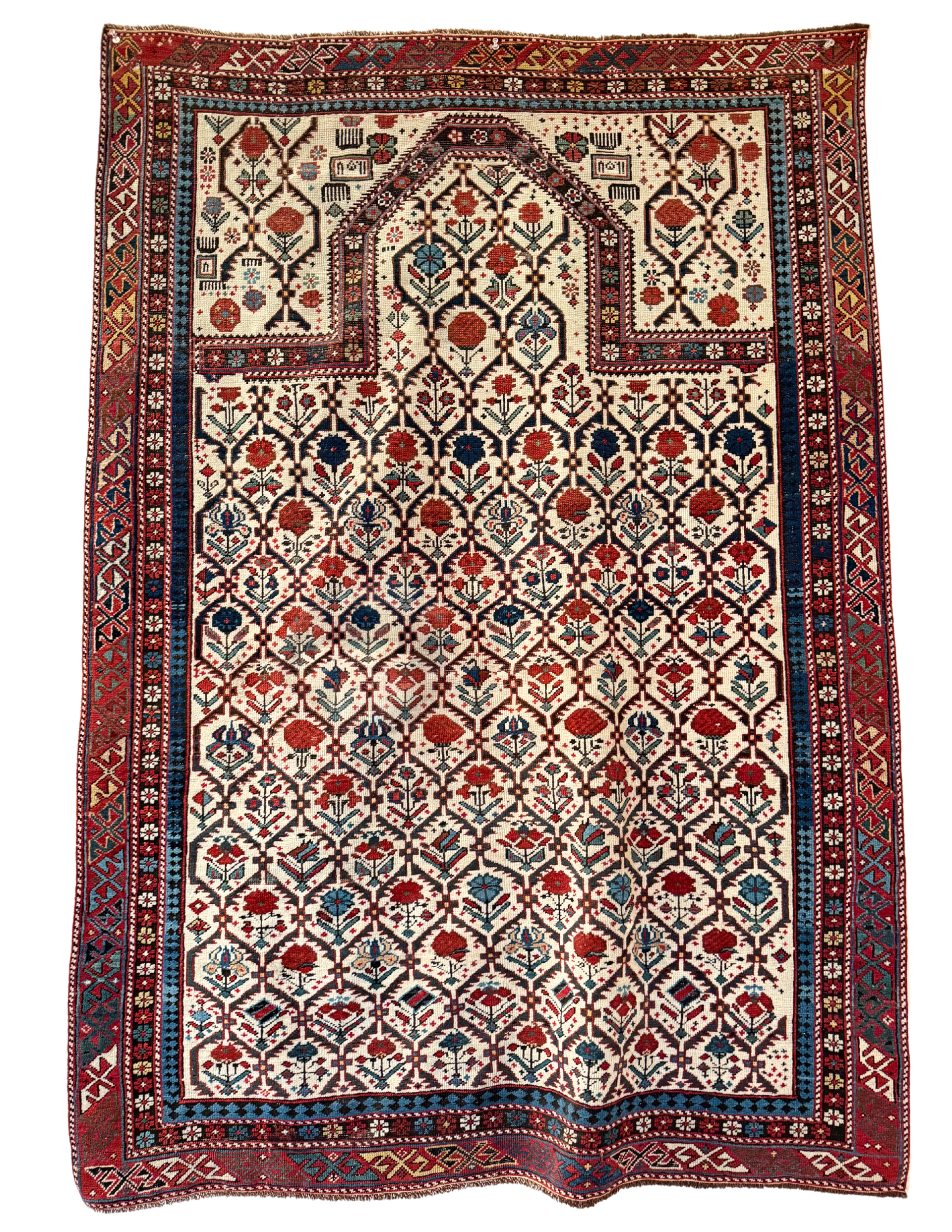 A rug with a floral pattern on it is hanging on a wall.