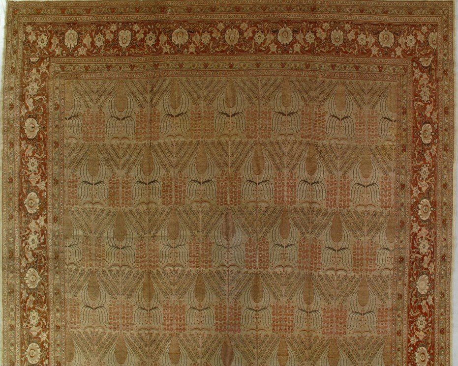 A rug with a pattern on it is hanging on a wall.