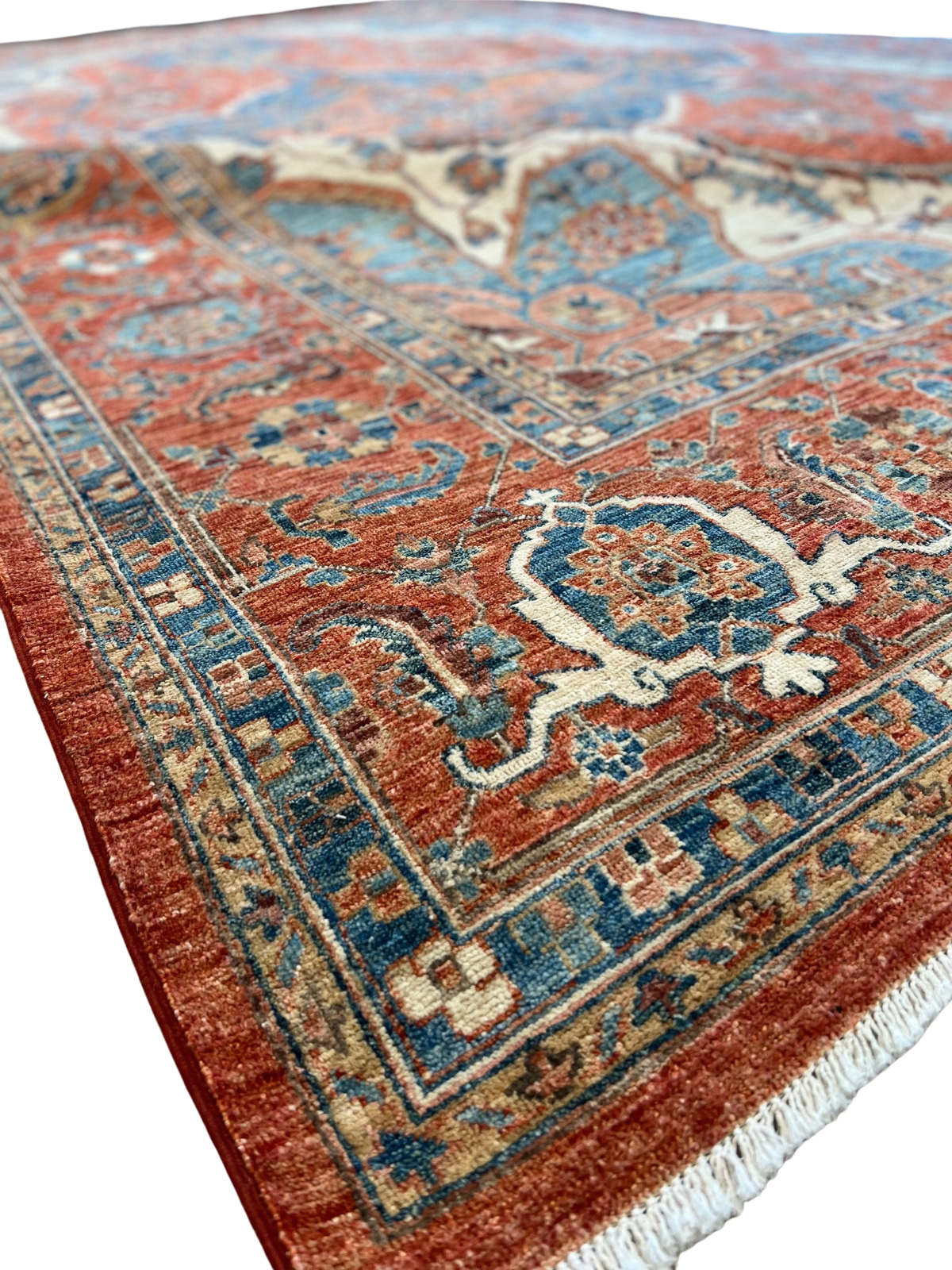 A close up of a rug with a pattern on it on a white background.