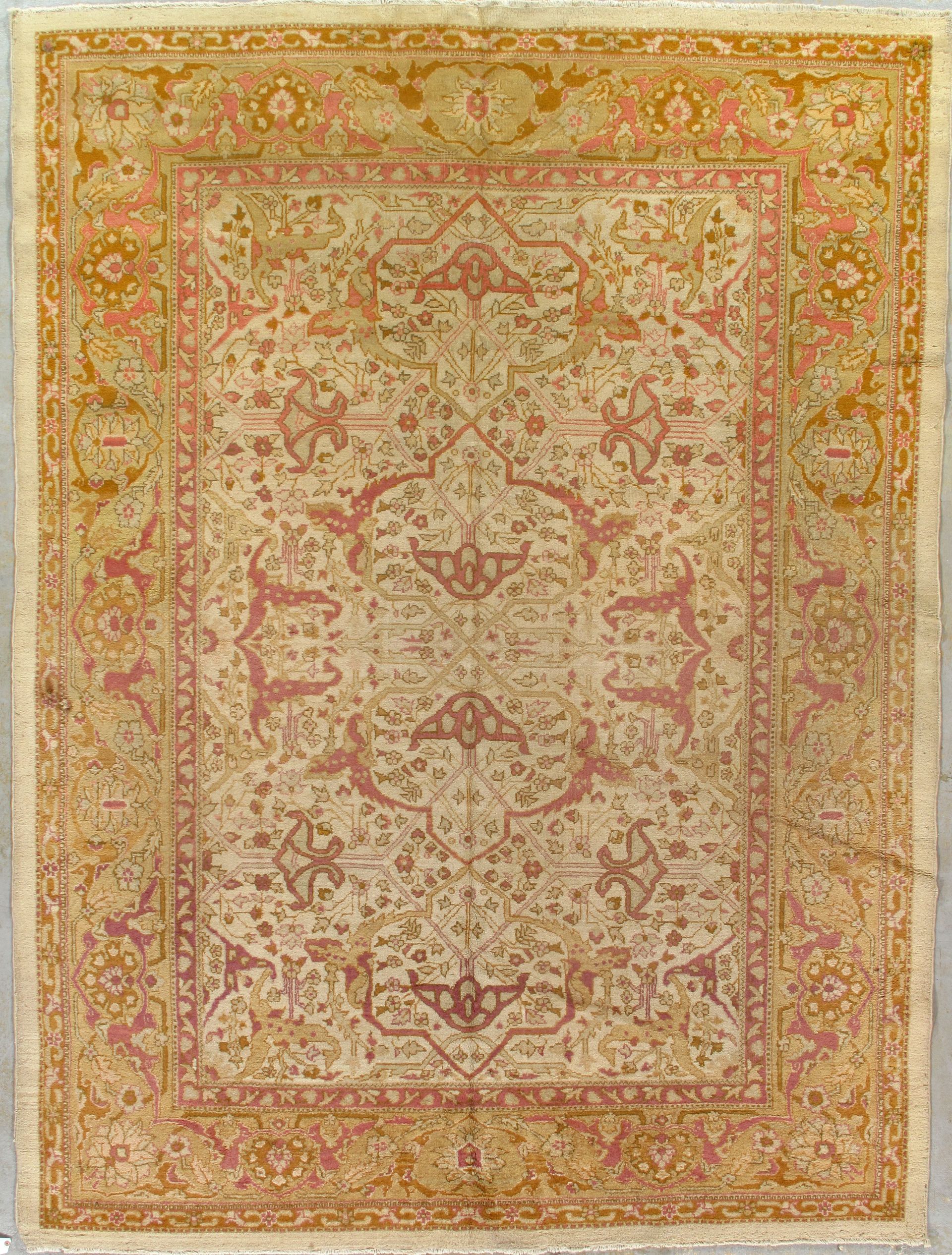 Persian rug with a cream-colored background, ornate pink and gold patterns.