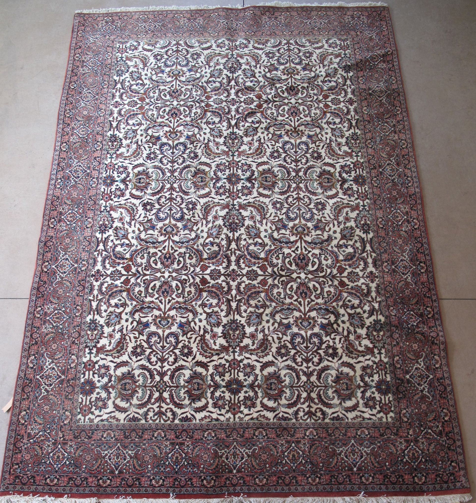 A rug with a pattern on it is sitting on a white surface.