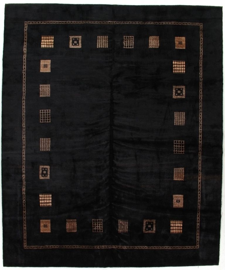 Black textile with a border of small geometric square motifs around the edges.