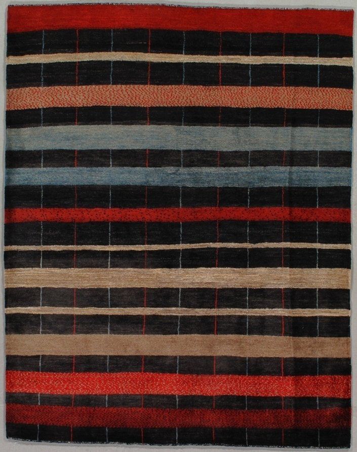A rug with red black and blue stripes on it