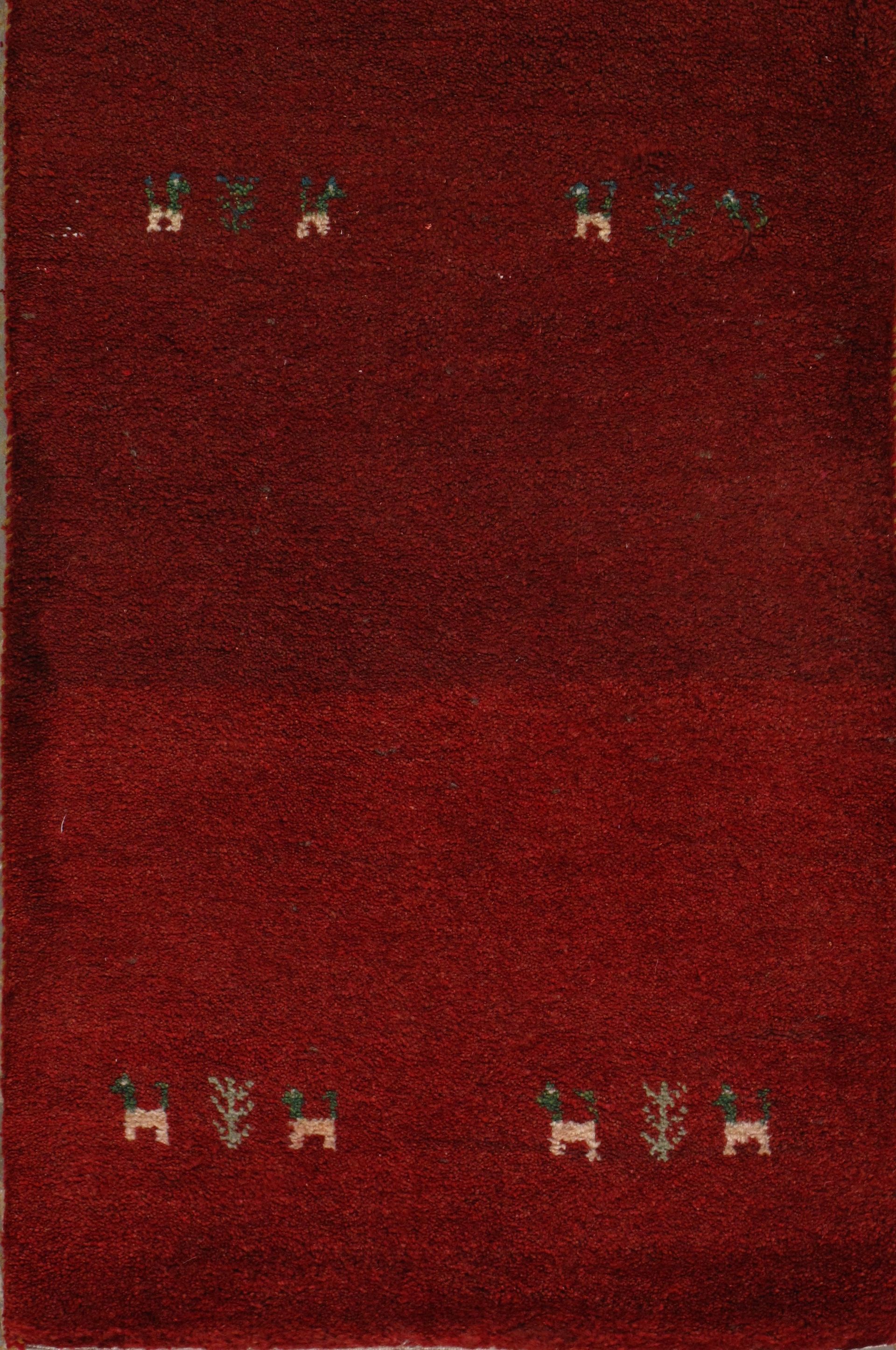 Red rug with small animal and plant motifs in a horizontal arrangement.