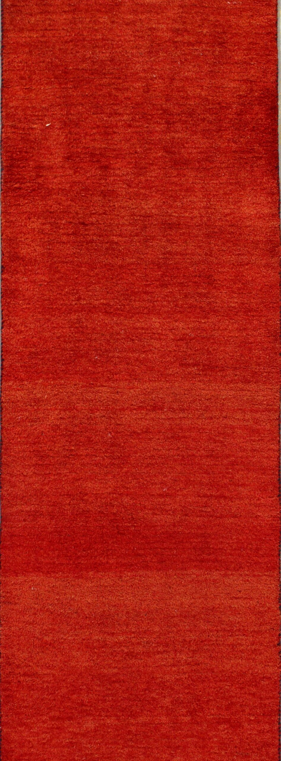 A close up of a red rug on a table.