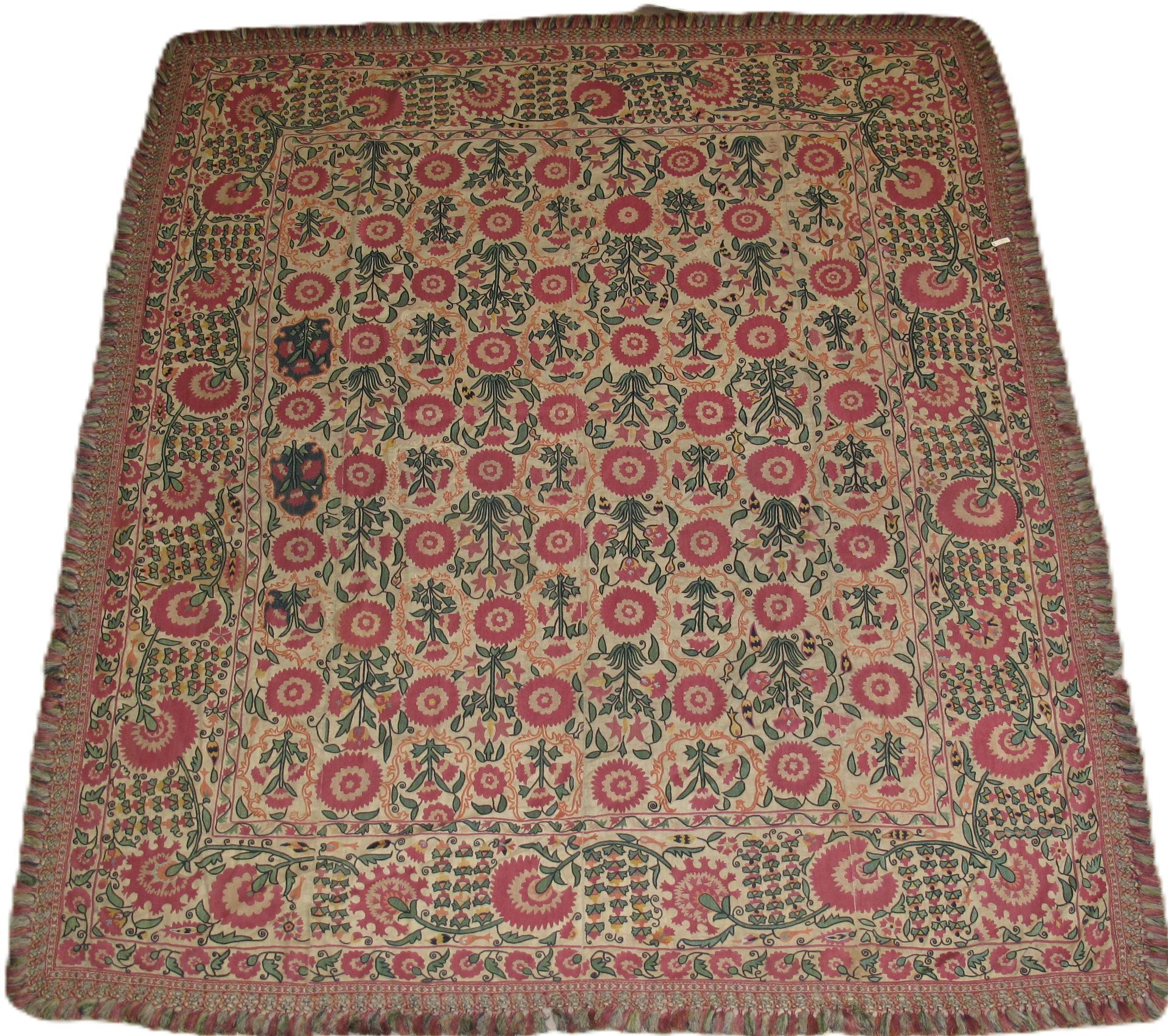 Square textile with red floral pattern and fringed border.