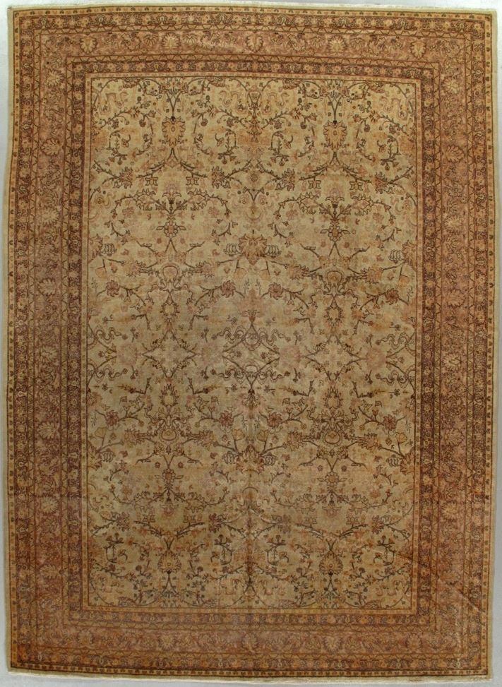 Beige and rust ornate oriental rug with a central floral pattern and border design
