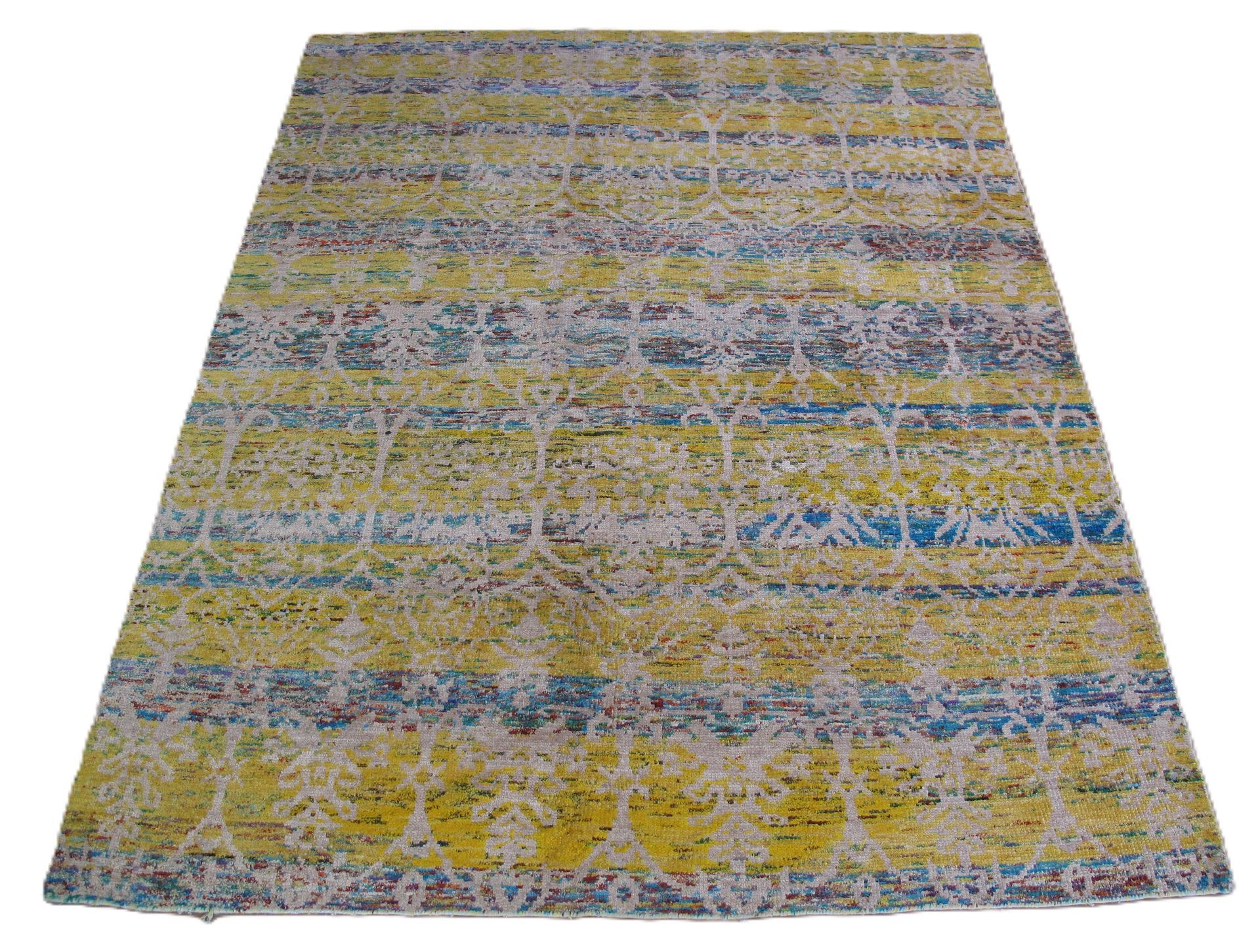 Yellow and blue patterned rug with white geometric accents.