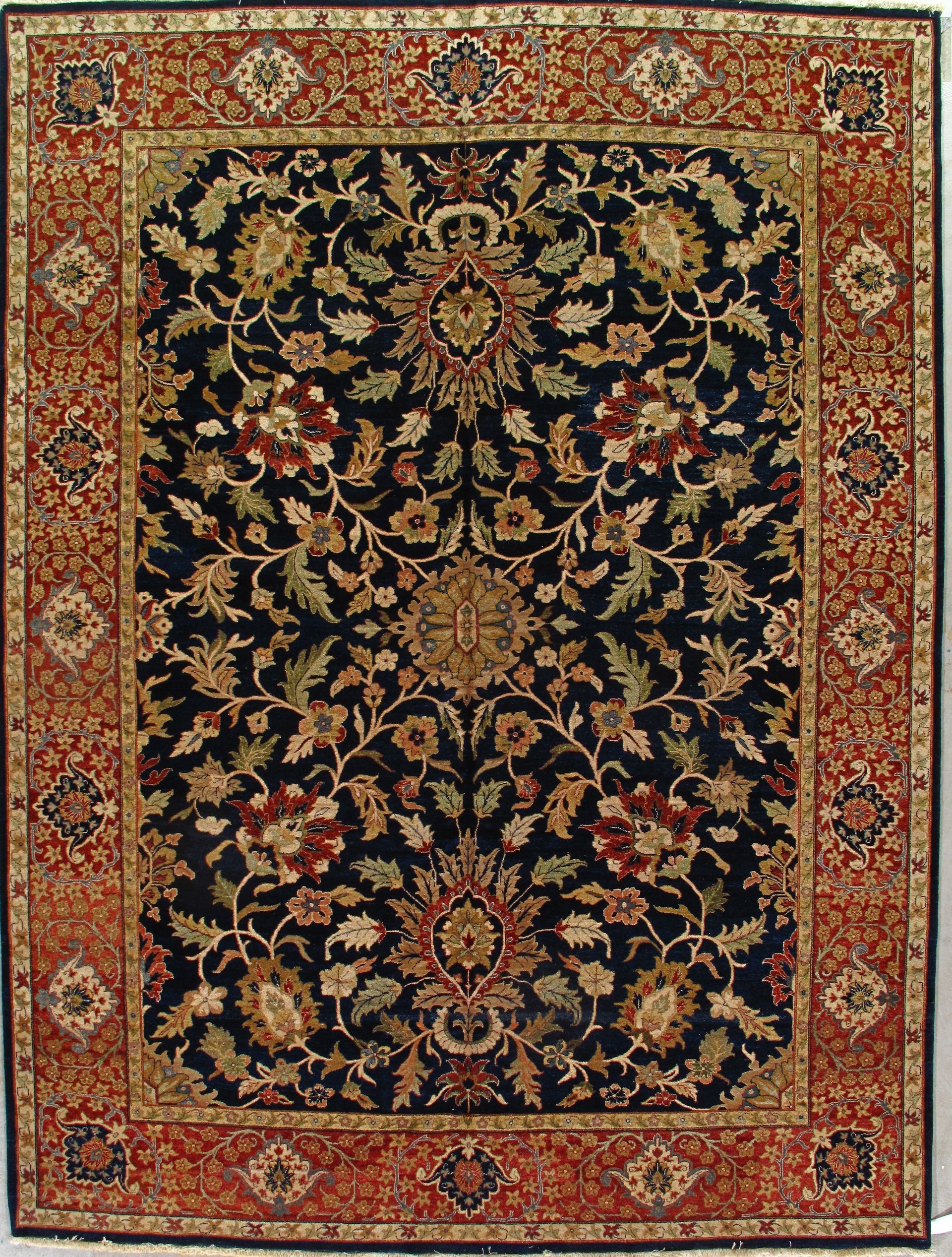 Persian rug with navy blue field, floral design, and red border.