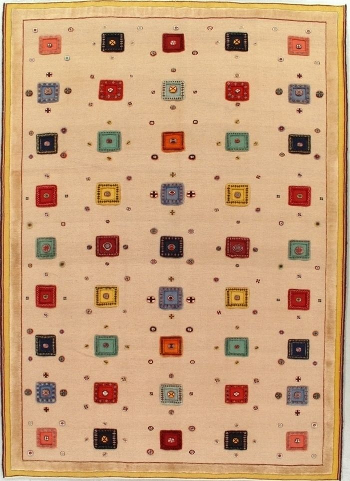 Beige rectangular rug with a pattern of colorful squares and small dots.