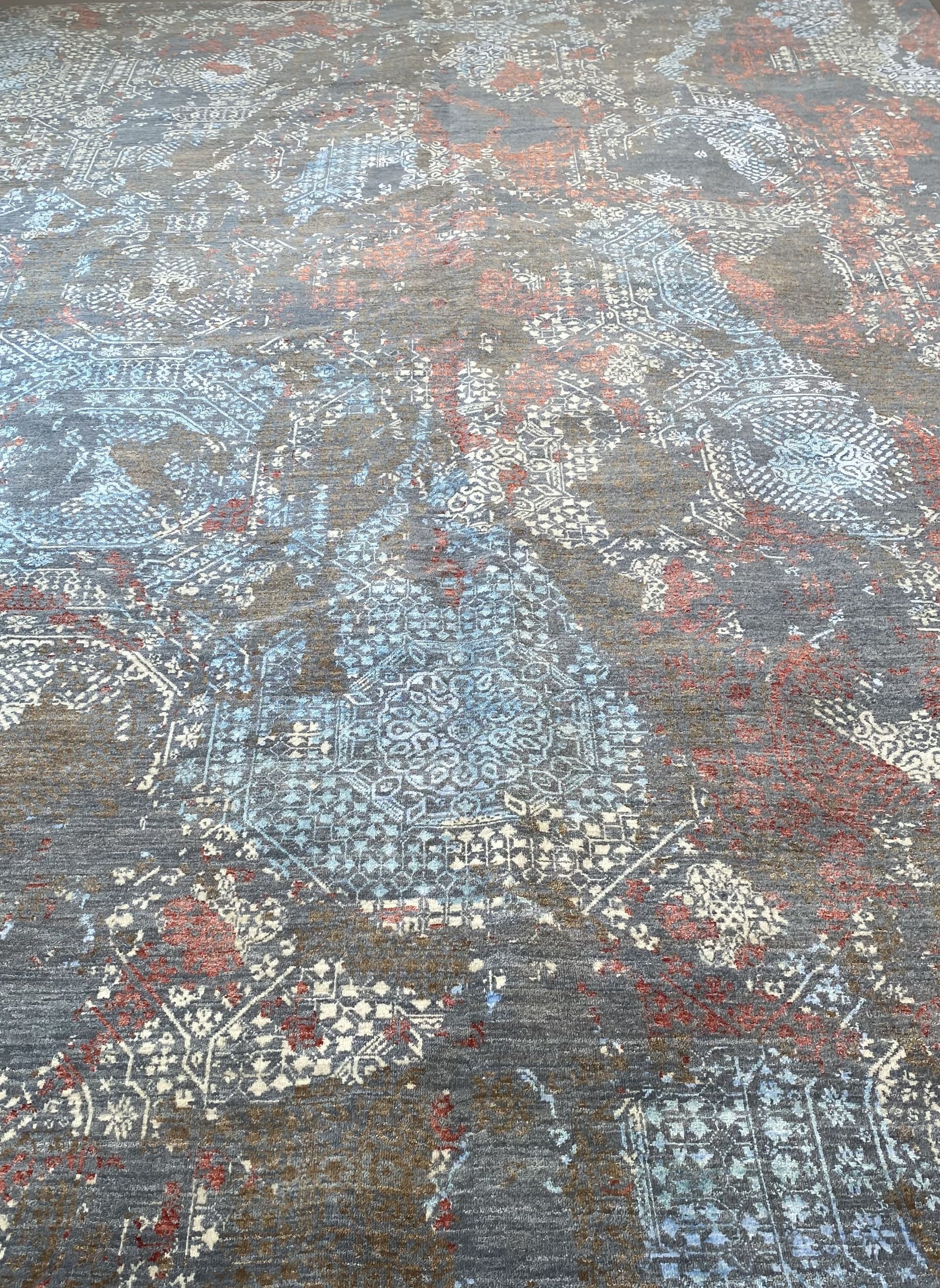 Abstract textured surface with mottled gray, blue, and red patterns
