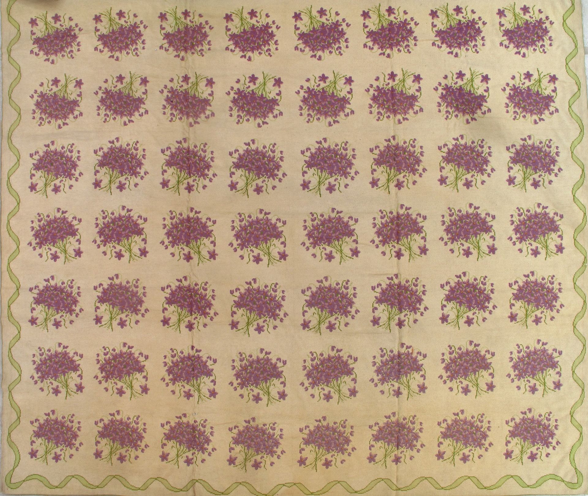 Repeated purple floral pattern on a beige background with a scalloped border