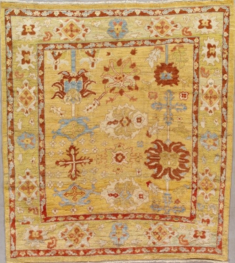 Yellow and red patterned rug with floral and geometric designs.