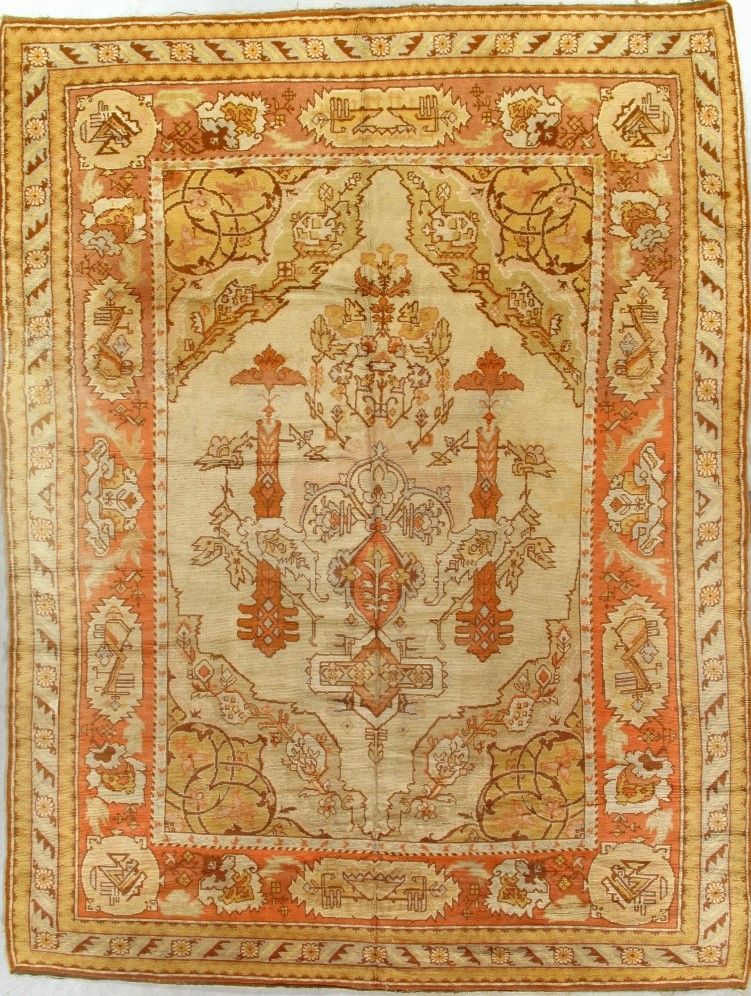 Antique beige and orange Oriental rug with ornate floral and geometric patterns.
