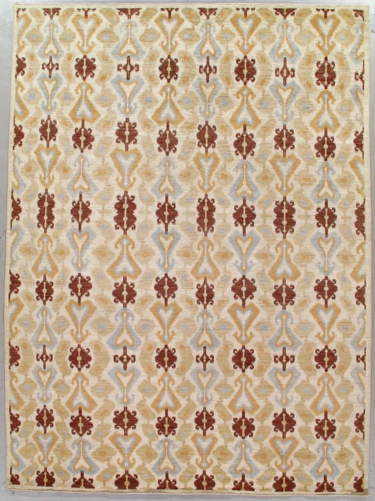 An area rug with a repeating vertical pattern in rust, tan, and gray on a cream background.