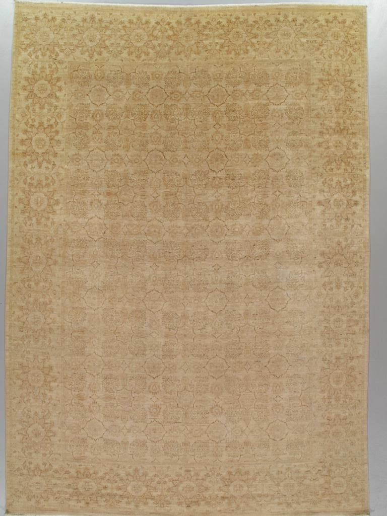 Beige patterned rug with a subtle border design on a plain background