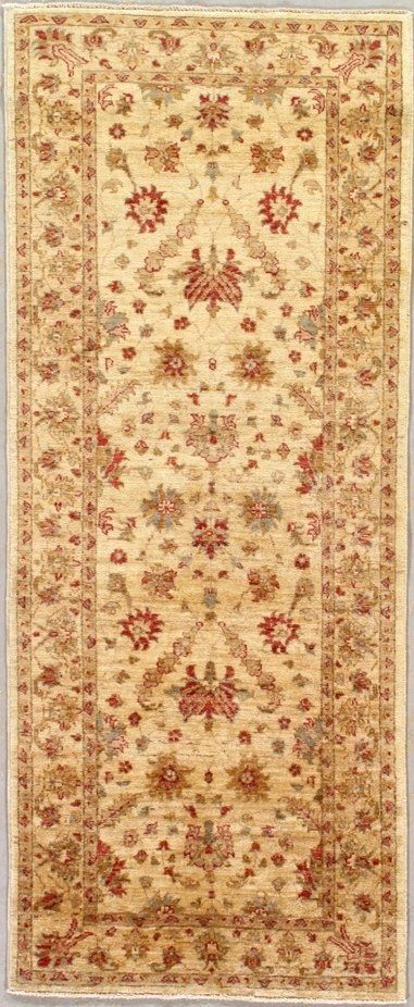 A rug with a floral pattern on it is hanging on a wall.
