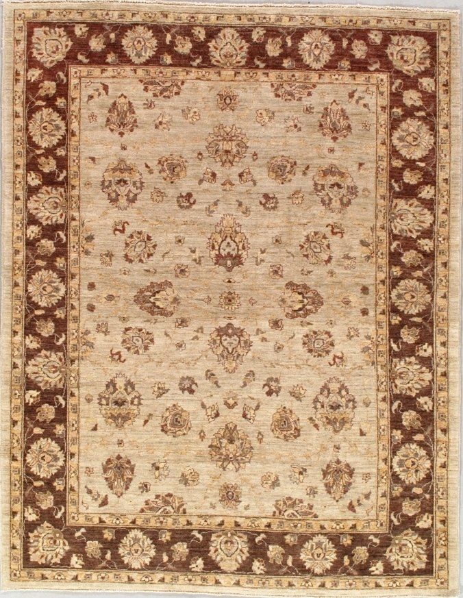 A rug with a brown border and flowers on it