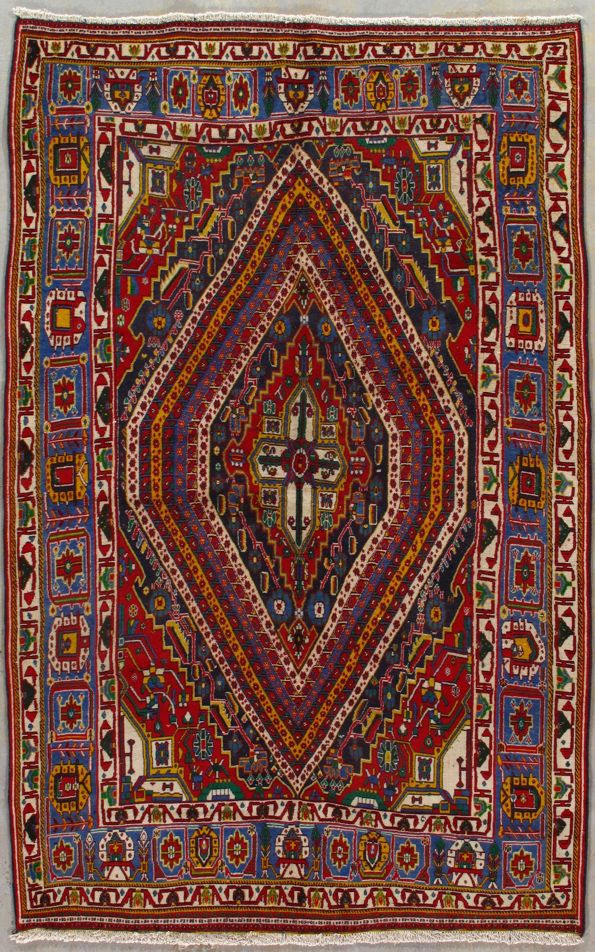 Colorful geometric Persian-style rug with a central diamond medallion and intricate border patterns