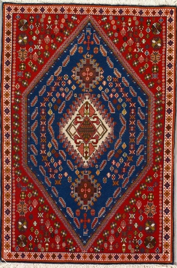 Red and blue rectangular rug with diamond-shaped pattern.