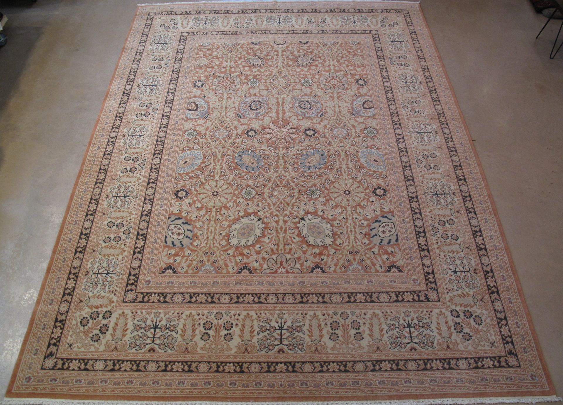 A rug with a floral pattern is laying on a white surface