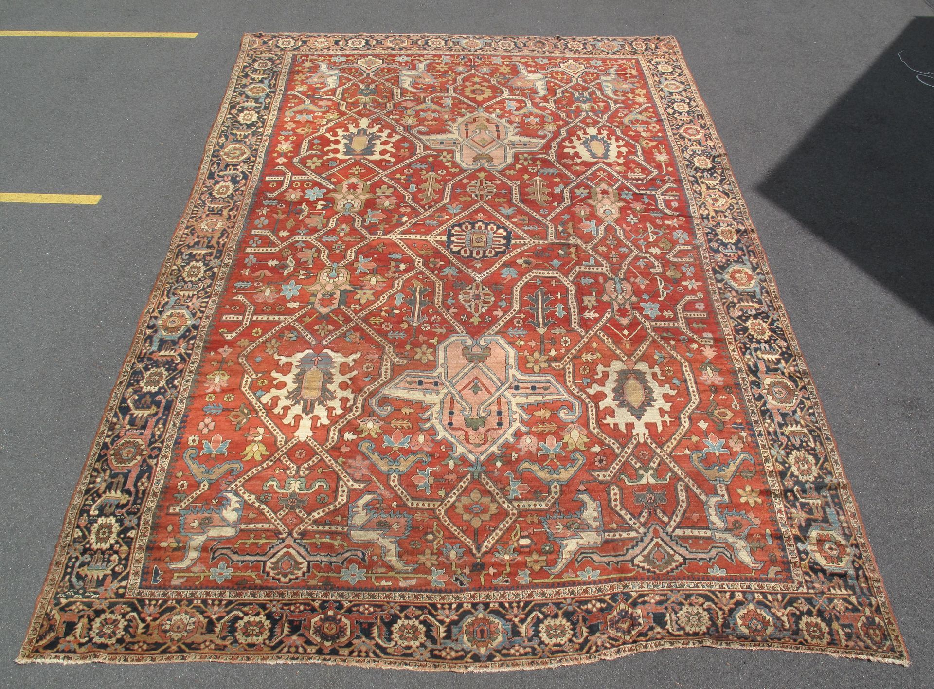 Red patterned Persian-style rug on a white background