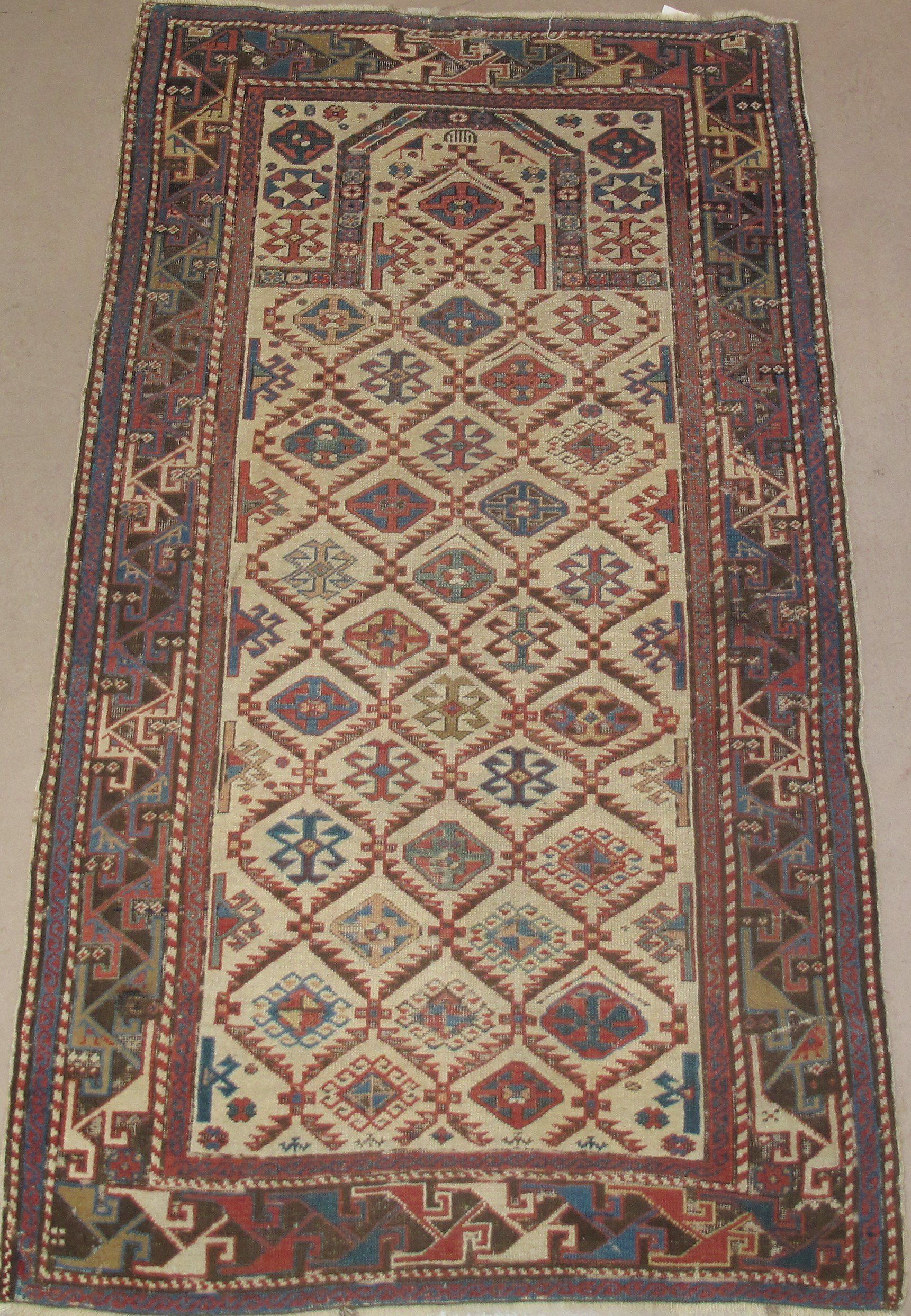 A rug with a geometric pattern and a purple border