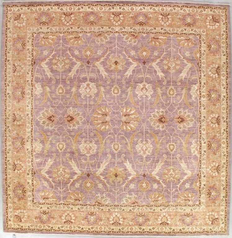 Square patterned rug with a lavender center and peach border. Floral designs.
