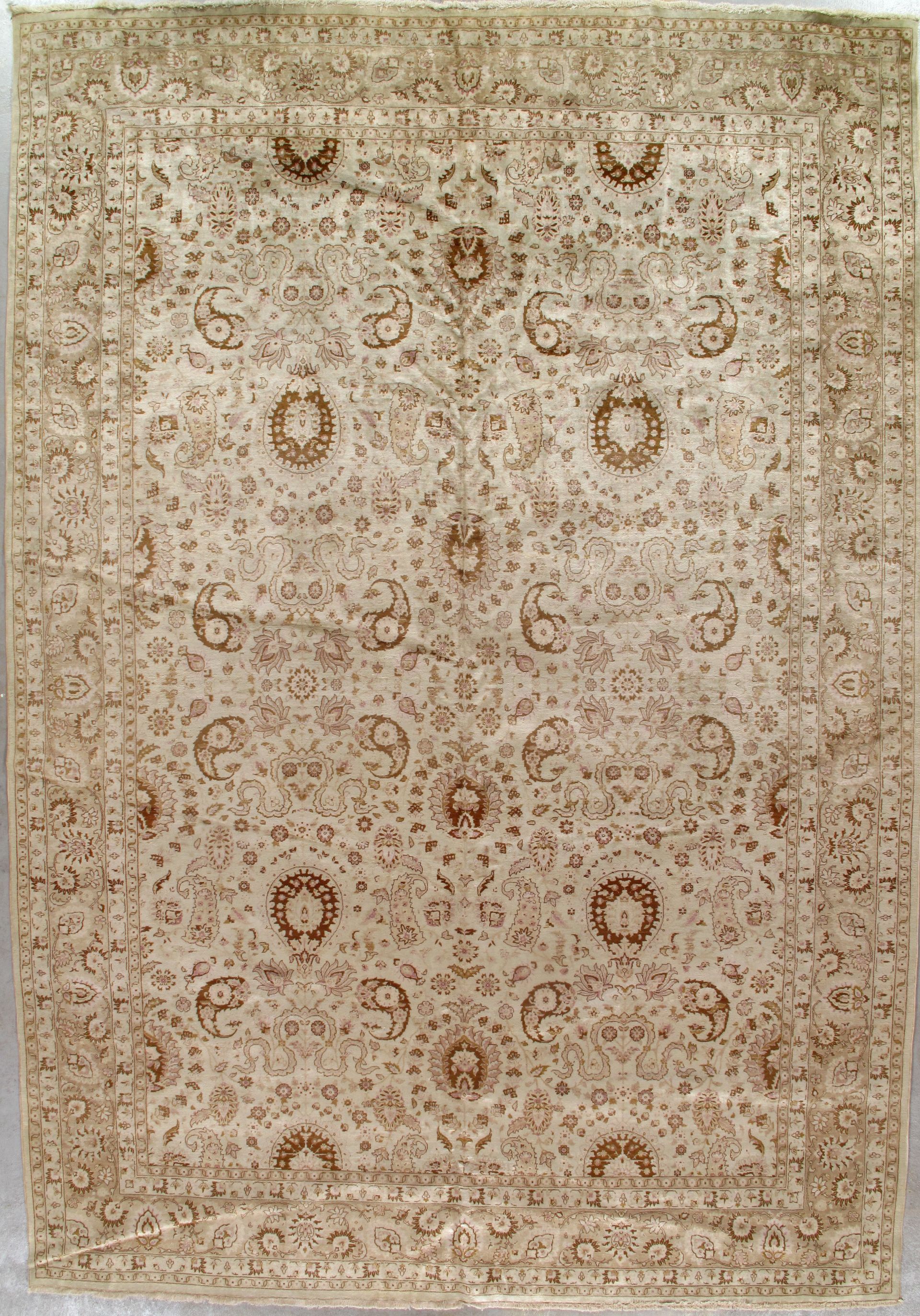 Antique beige Persian-style rug with intricate floral medallion patterns and borders