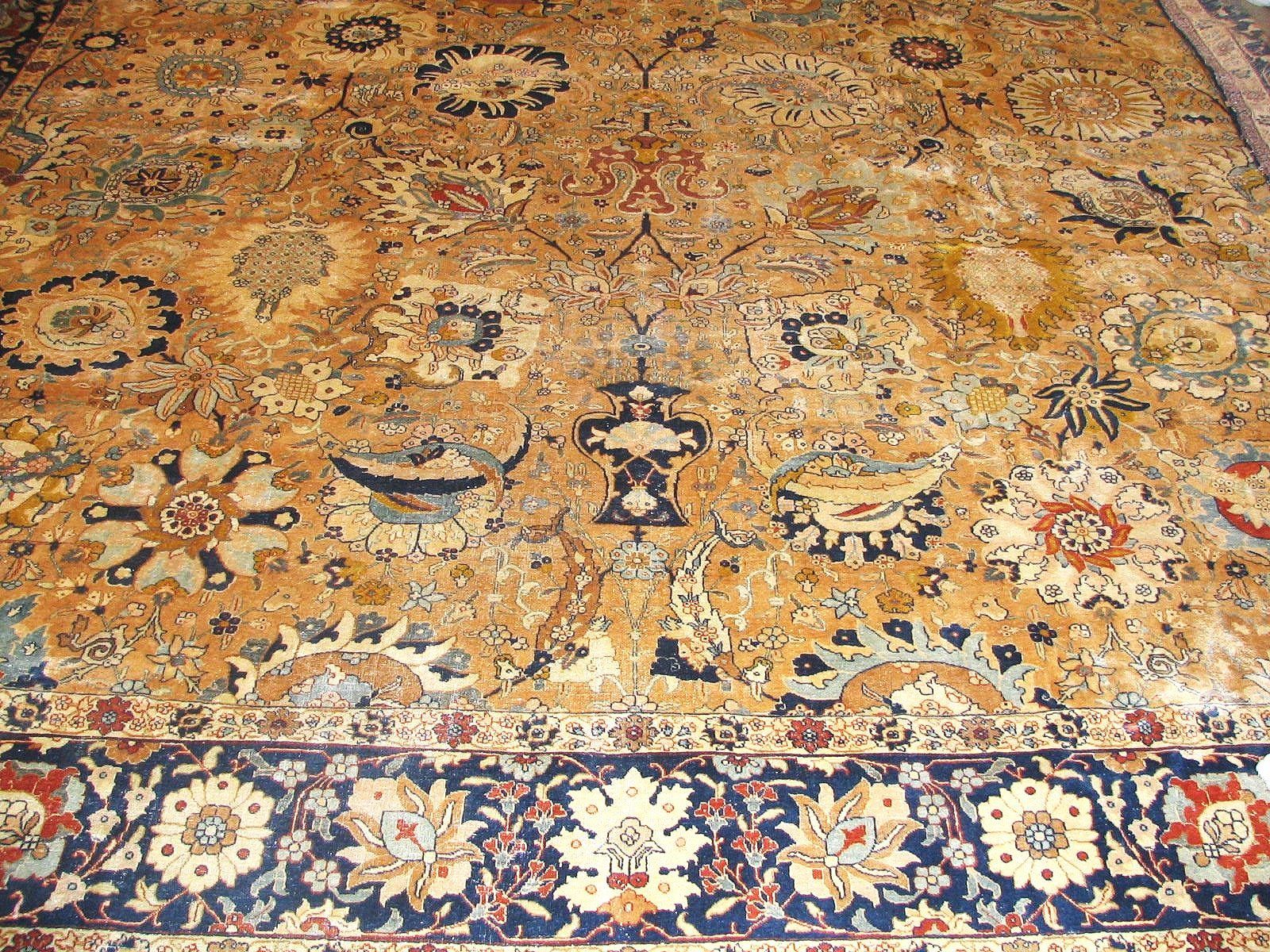 A rug with a floral pattern and a blue border