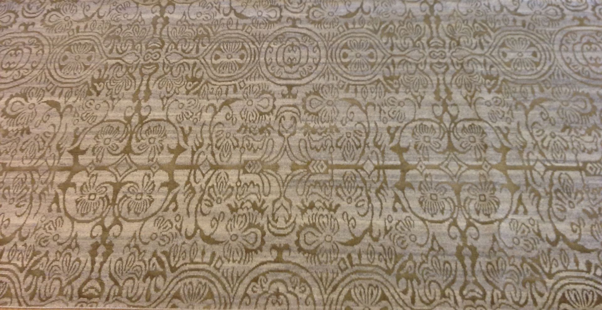 Dense beige and gray ornamental pattern with repeating floral and abstract motifs