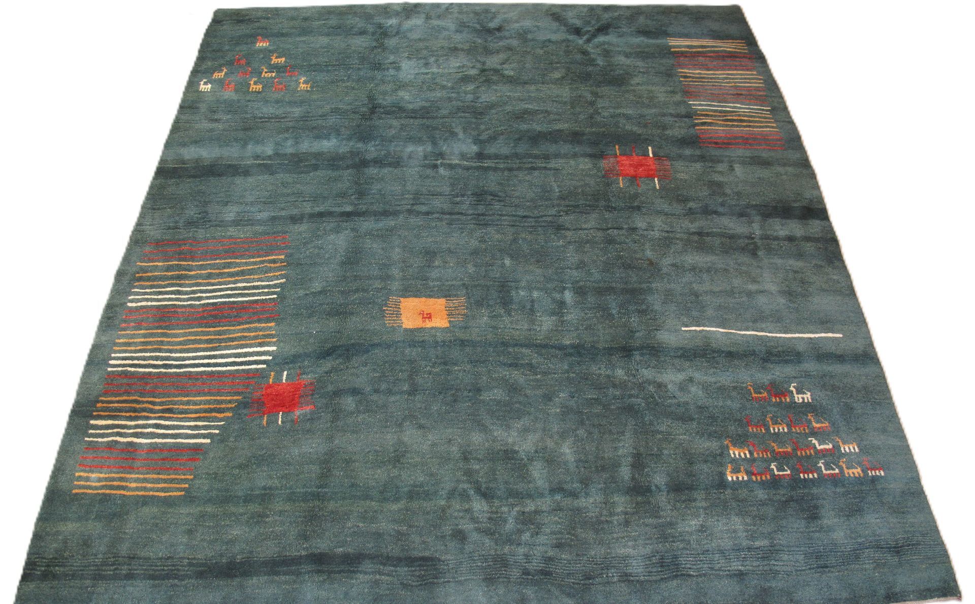 Blue area rug with red, white, and brown geometric designs.