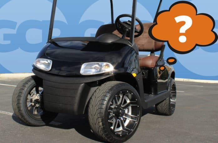 A black golf cart with a question mark above it