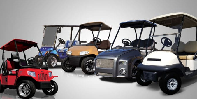 A group of golf carts are lined up in a row.