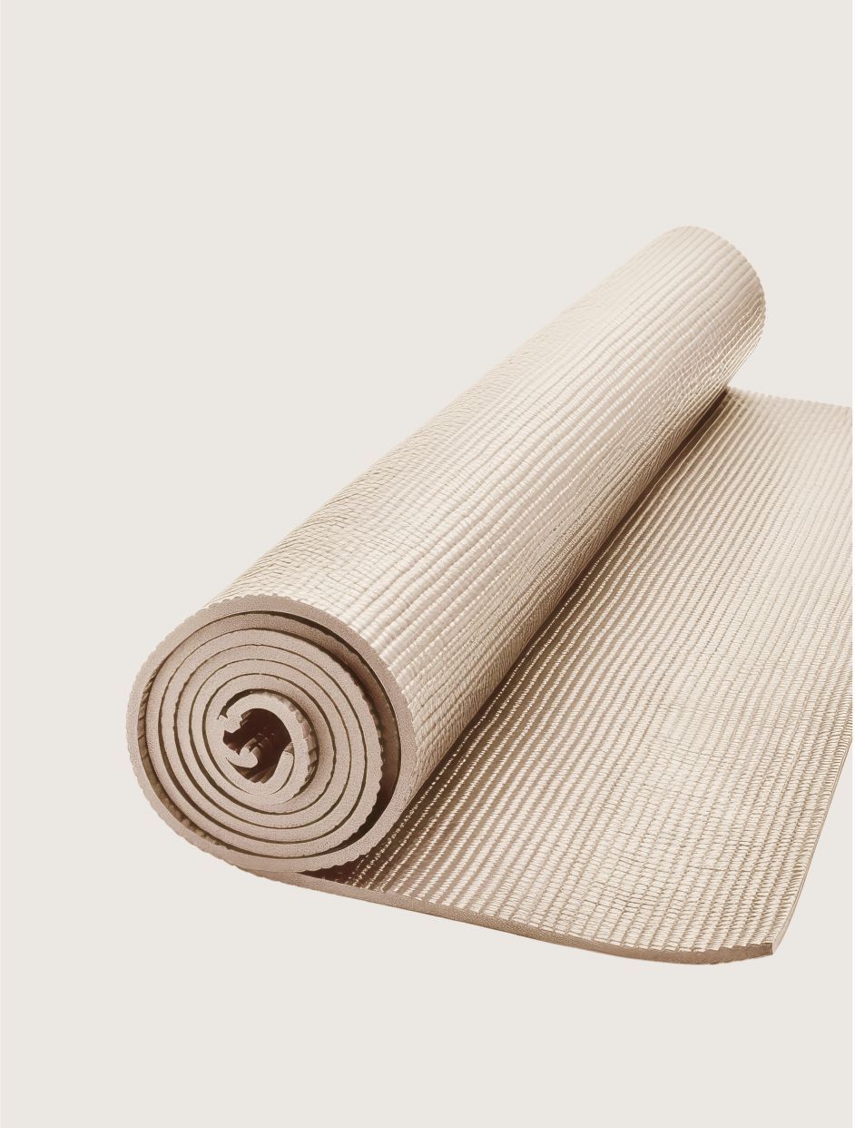 Rolled beige woven mat with a textured surface, partially unrolled on a light background