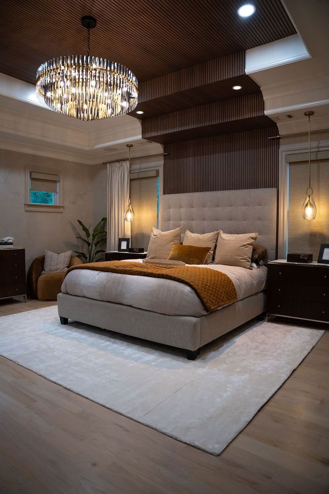 Luxury bedroom with a beige upholstered bed, chandelier, wood-paneled ceiling, and warm ambient lighting