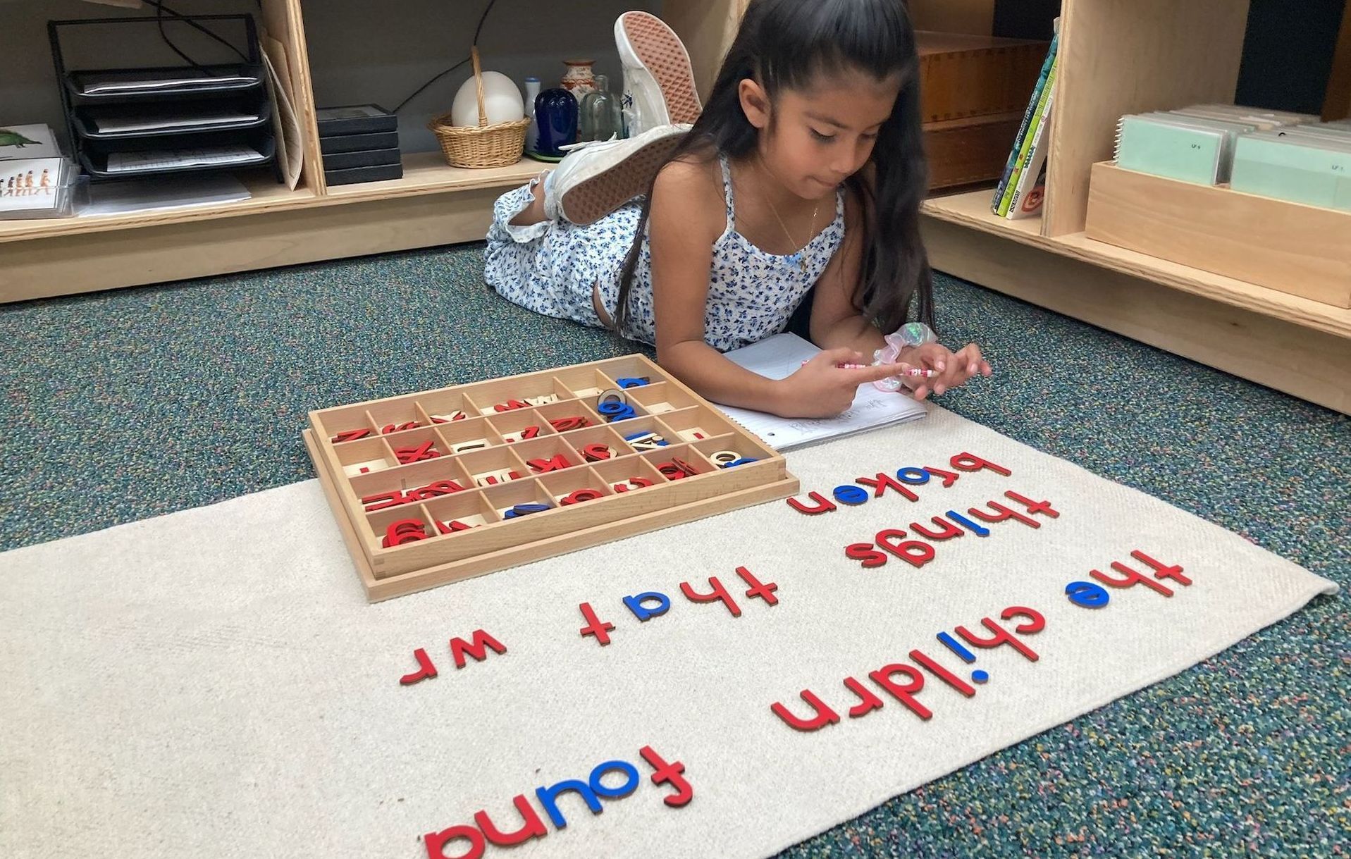 Montessori child working with the movable alphabet. 