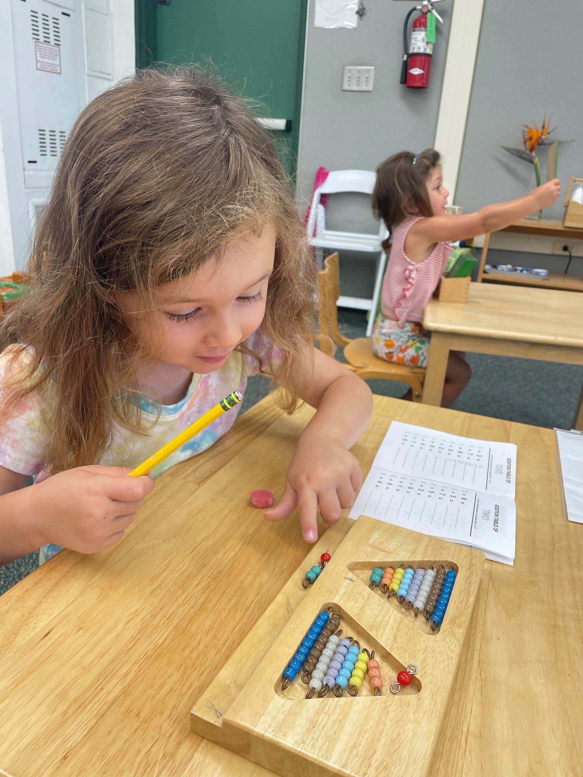 Montessori child working with math beads.