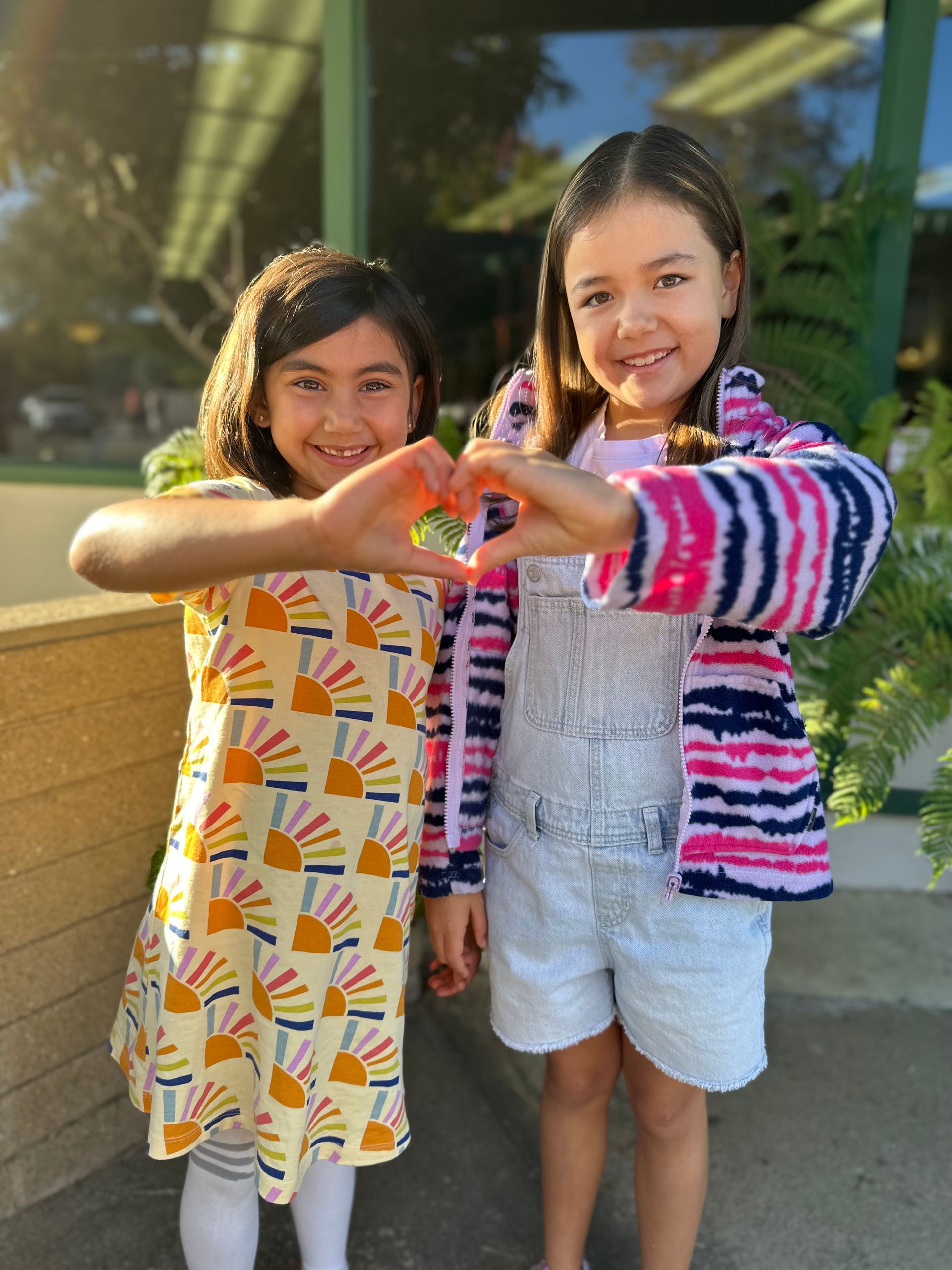 montessori children doing heart sign