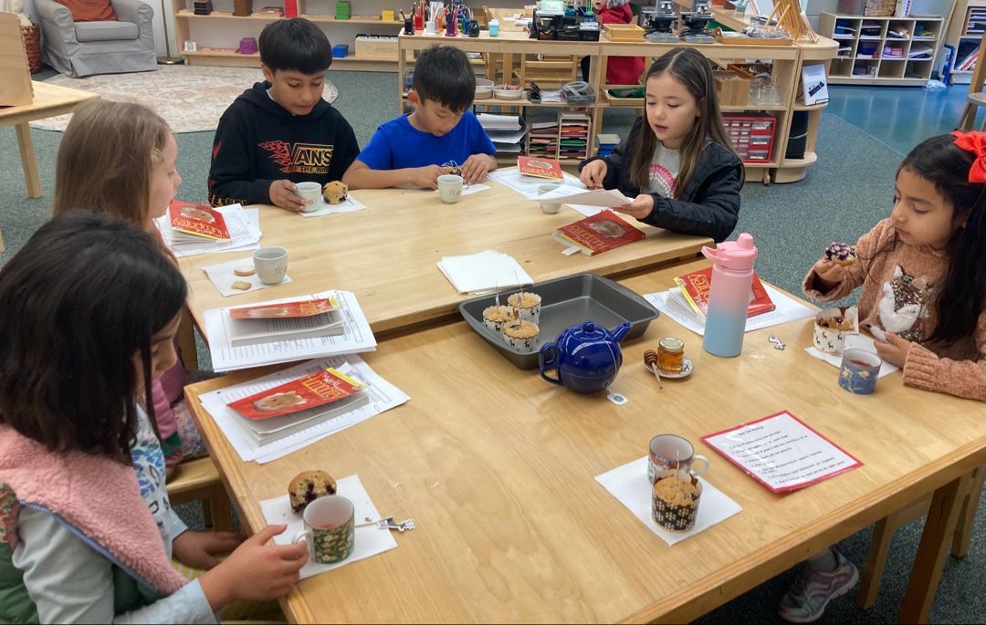 Montessori students working and having a snack.