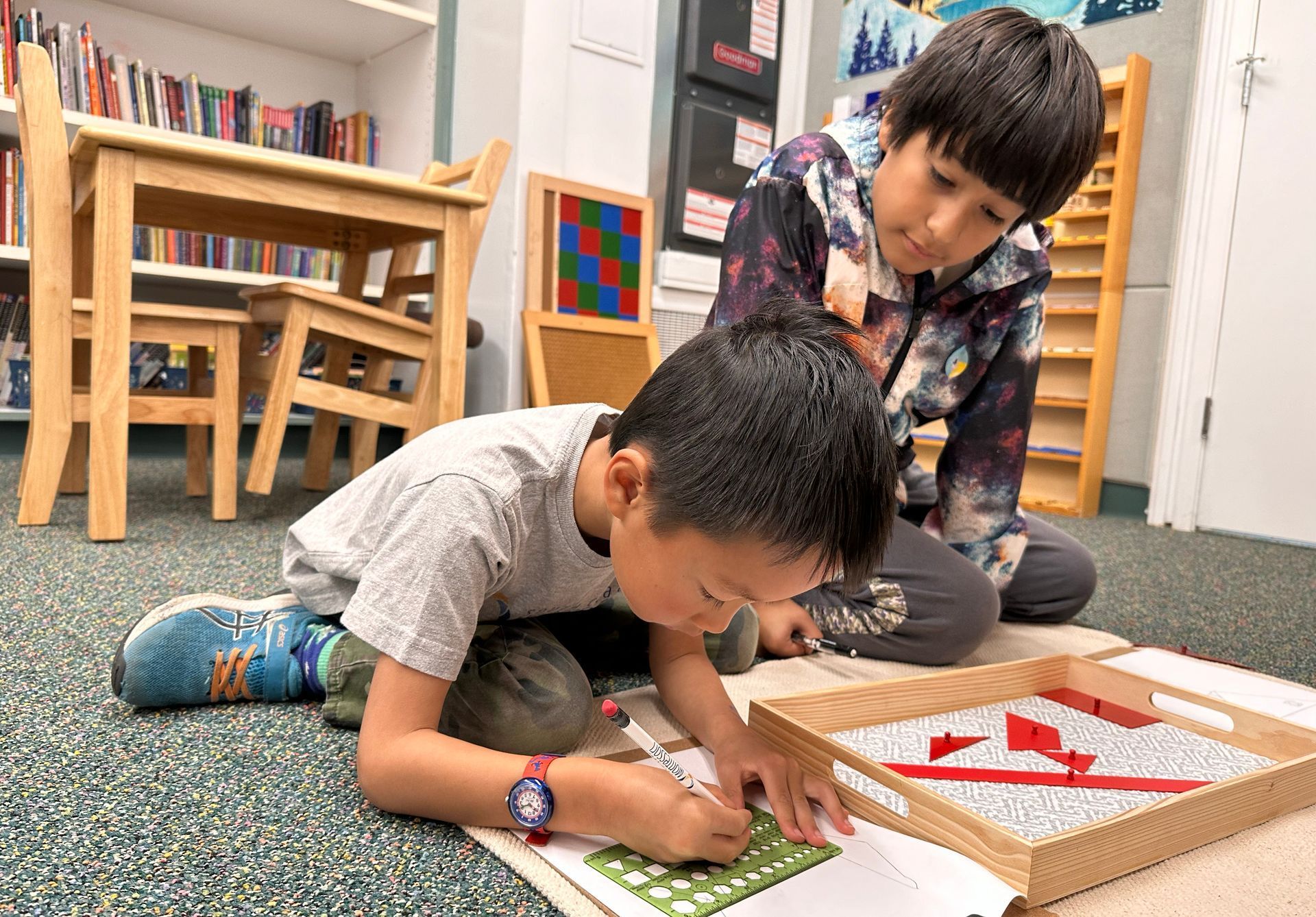 Montessori students working with math materials. 