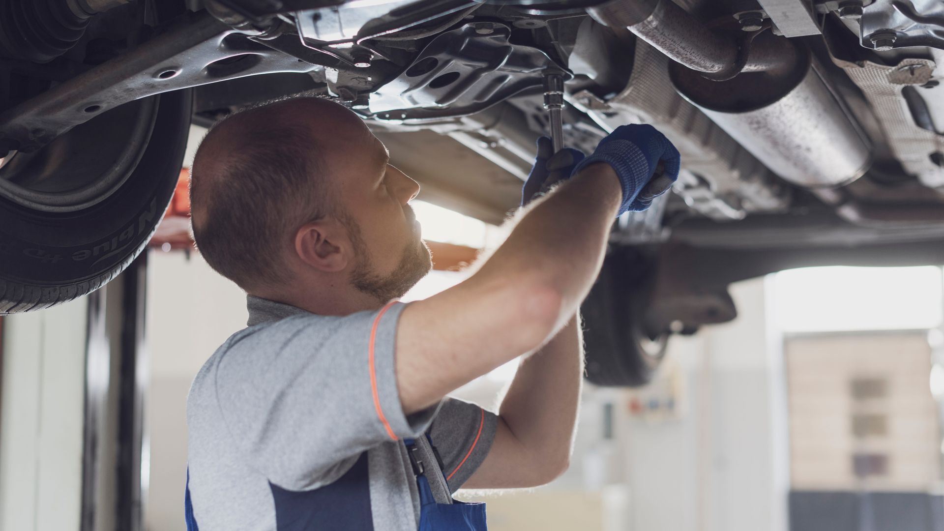 car mechanic working on car